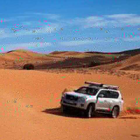 4x4 jeep driving through the Erg Chebbi dunes in Merzouga
