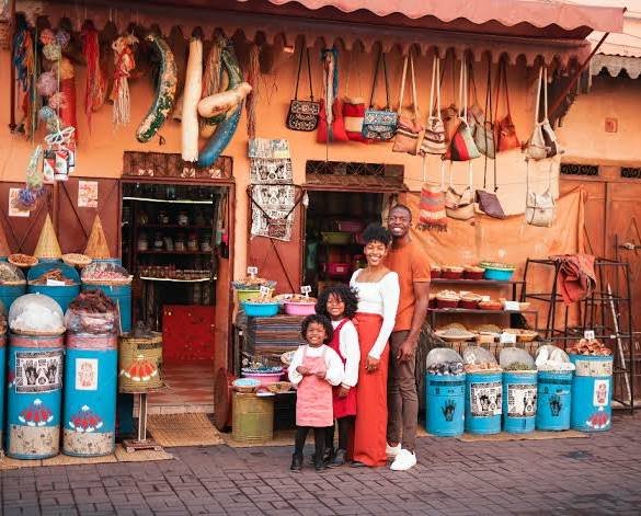 Morocco travel with kids: a family enjoying a trip through the desert