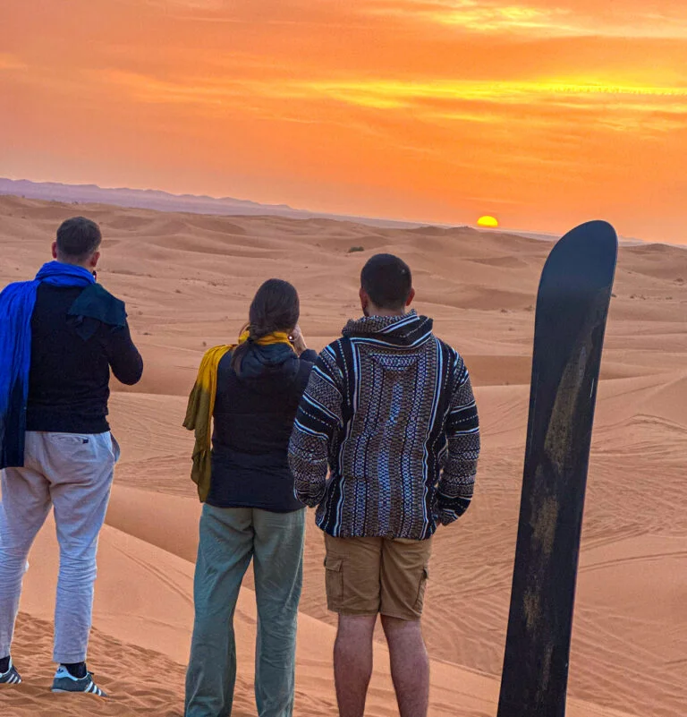 Sandboarding down a dune in Merzouga, a popular activity on a second night in the desert